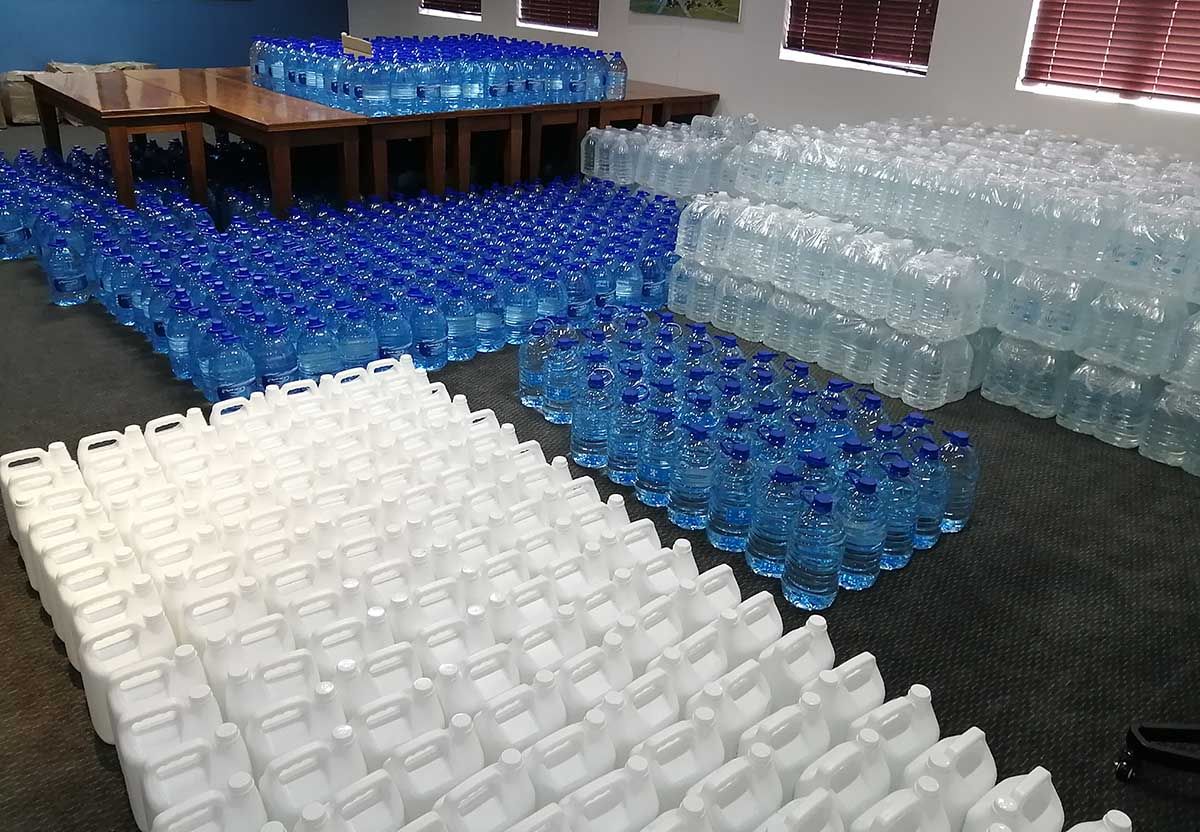 Bottled water and sanitisers ready to be handed out in communities, healthcare facilities and schools