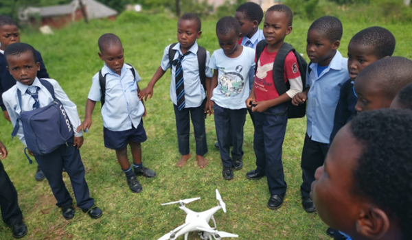 children around a drone
